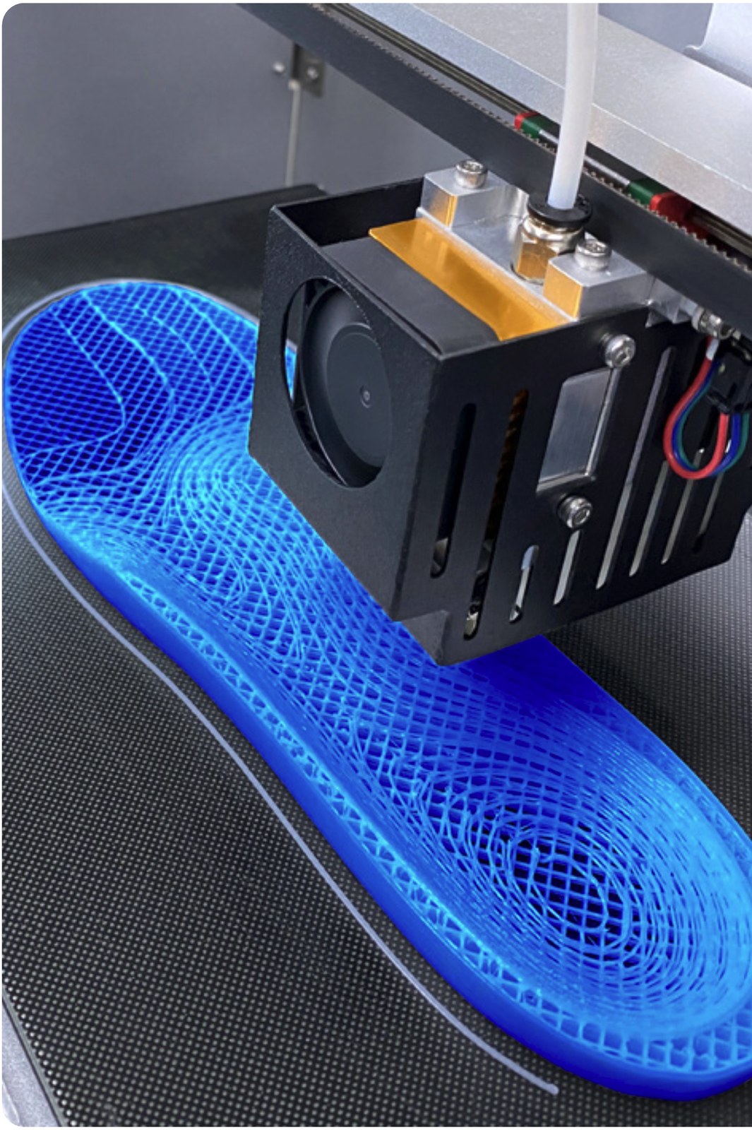 A lattice-structured insole part-way through 3D printing.